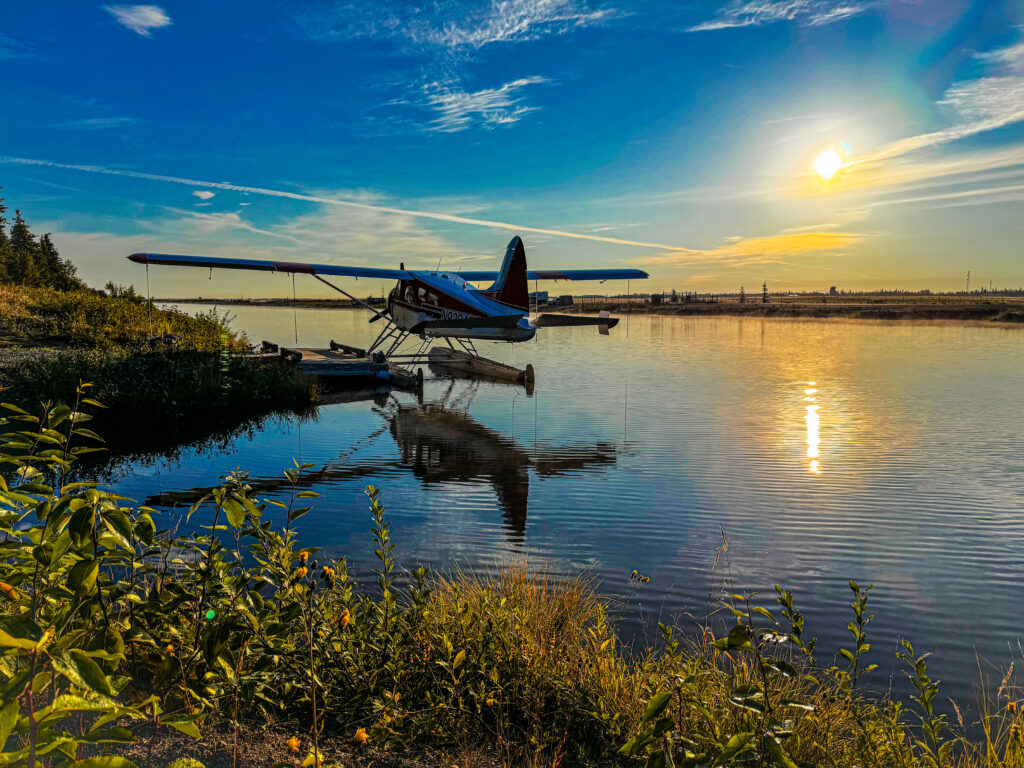 Floatplane moored on a calm river at sunrise